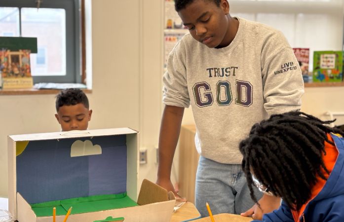  scholars working on a project together